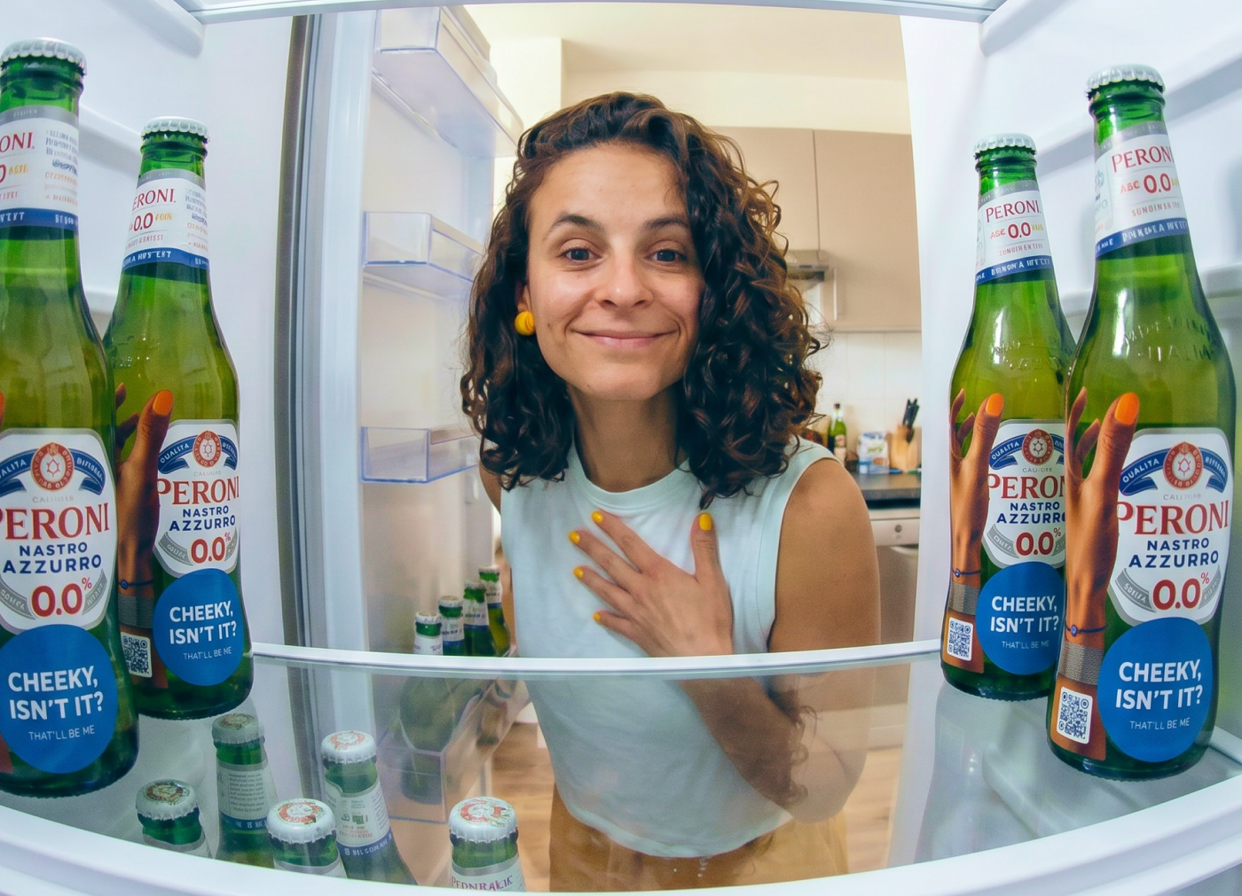 Irene Martins inside a fridge filled with Peroni bottles